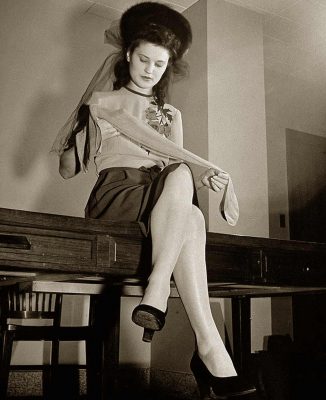 1940s stockings - 1942 woman inspects her Nylons - ©Time Inc