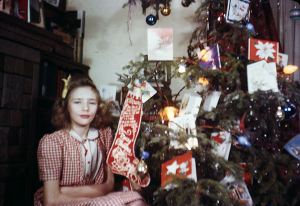 Young woman by Christmas tree 1940's