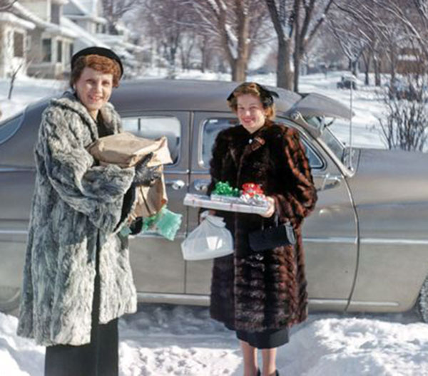 Two women with Christmas presents in the snow 1950's