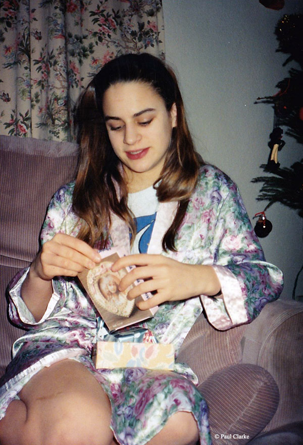 Gemma unwrapping Christmas presents in 1993