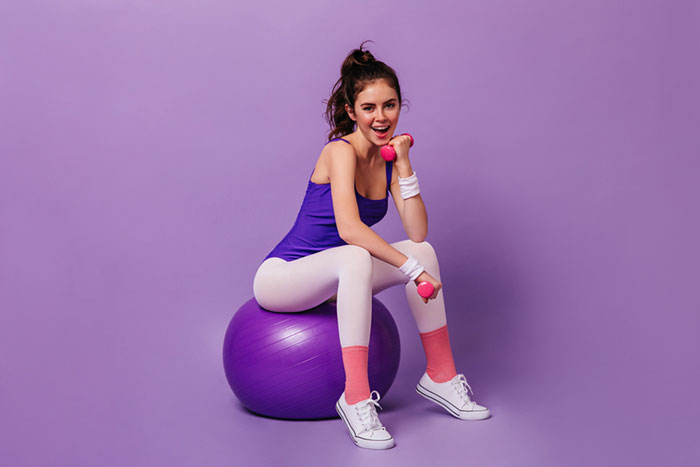 Young woman wearing a spandex leotard and leggings like in the 80s