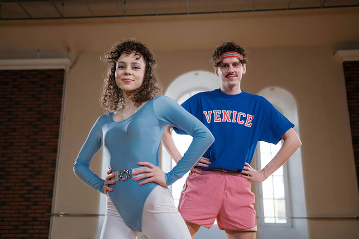 man and woman in retro workout outfits, inspired by 1980s fashion trends